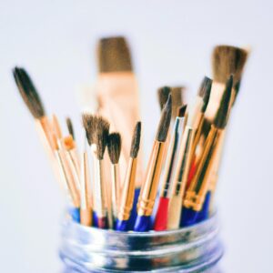 Collection of various paintbrushes in a jar ready for artistic projects.