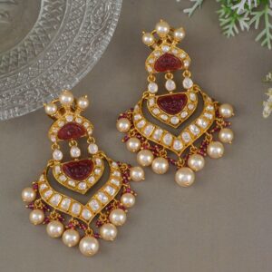 Pair of luxurious beaded earrings with pearls and gold accents on a gray surface.