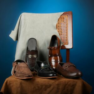 Stylish collection of men's leather dress shoes on a chair, perfect for fashion and formal occasions.