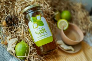 Close-up of organic honey jar with dried lime and natural elements for authentic feel.